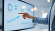 © heerim studio - Professional Hand Point to Business Data Charts on Screen Display in Office