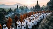 © Dimas - Group of Buddhist monks and devotees walking in procession around ancient Borobudur temple complex at sunrise