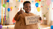 © Morrina - International Potato Day toddler boy wearing potato costume holding potato power sign thumbs up satisfied for children education celebration party event marketing promotion lifestyle content design