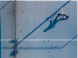 © 晨啸 周 - Aerial view of a young girl playing tennis on a blue court, her long shadow naturally mirroring her dynamic swinging motion.