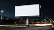© The Little Hut - Blank large billboard at night on highway with car light trails and city lights in background