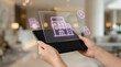 © SYATRI RAWU - Futuristic digital interface on a transparent tablet displaying smart building management, advanced security, and property technology solutions