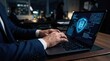 © syful - Man in dark suit typing on laptop with glowing security shield and binary code hands