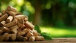 © sornram - A stack of firewood sits elegantly in a serene outdoor setting, surrounded by vibrant greenery, creating a cozy and inviting atmosphere.