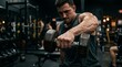 © Donni - Man lifting dumbbell during intense weight training workout in gym