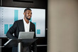 © peopleimages.com - Laptop, screen and black man in office with presentation for finance statistics, graphs or charts. Computer, meeting and male financial manager with investment forecasting at conference in workplace.