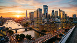 Golden hour sunset over the iconic London cityscape, with the River Thames winding through modern skyscrapers and historic bridges