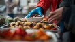 © Fukuro - Volunteer serving food to people in need at a soup kitchen.