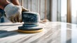 © Alal.ST - Worker using an electric sander to smooth a marble countertop