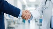 © Masque - Physician and pharmaceutical representative shaking hands after a successful business partnership negotiation.