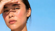 © May - Sun damage and urban pollution skin concern, woman shading eyes from bright light on blue background, high-end sun care advertising with massive copy space