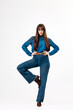 © wedmoments.stock - Model in casual denim outfit posing in bright minimalist studio interior. Concept fashion basics and clean aesthetic.
