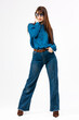 © wedmoments.stock - Modern fashion model wearing denim and shirt posing in bright minimalist studio. Concept casual wardrobe and contemporary fashion.