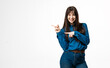 © wedmoments.stock - Fashion model pointing to the side with fingers on white studio background. Concept presentation, advertising and copy space.