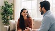 © Nur - Happy woman and male therapist engaging in a counseling session in a cozy bright living room with large window and green plant for mental health support and emotional well-being