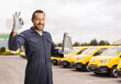 © Ljupco Smokovski - Mechanic holding engine oil in front of vans