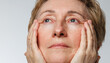 © kkolosov - Close portrait of senior woman with natural skin texture and aging beauty concept.