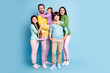 © deagreez - Happy smiling family of five posing together in colorful casual clothes against a blue background — parents with three children showing warmth, togetherness and modern family life