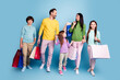 © deagreez - Family shopping together smiling with kids carrying colorful shopping bags and casual spring fashion