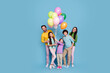 © deagreez - Happy family of five holding colorful balloons and smiling together against a blue studio background, parents and three children enjoying a cheerful celebration and playful moment