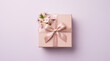 © ELmidoi-AI - Pink gift box with elegant satin ribbon bow and cherry blossoms on purple background, Mother's Day present, spring celebration flat lay, feminine birthday gift