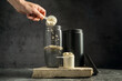 © Inga - Vanilla whey protein powder and shaker, food supplements, dark background. Making protein shake drink.