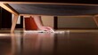 © Aliaksandr - Hand reaching with a rag under dark furniture to wipe dusty hardwood floor, close up showing meticulous deep clean housework and careful home maintenance efforts
