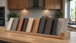 © Pete - Kitchen cabinet and countertop material samples displayed on wooden surface. Various wood grains laminates and stone finishes show color and texture choices for home renovation.