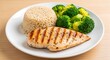 © FARIHA - Grilled chicken breast served with rice and steamed broccoli on white plate