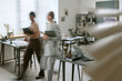 © AnnaStills - Wide shot of diverse businesswomen walking through office carrying folders, creating motion blur and teamwork concept. Ideal for corporate workflow, productivity, collaboration marketing