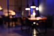 © Pixel-Shot - Blurred view of dark office with workplace, folding screen and glowing lamps at night