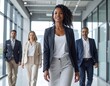 © Pandi - Confident woman leads diverse team in modern office
