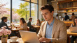 © Usman - Young professional entrepreneur working on a laptop in a bright, sunny cafe during a late spring morning with vibrant colors, cherry blossoms visible through the window, and a cup of coffee.