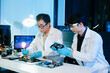 © Nuttapong punna - Asian engineers and scientists working with computer hardware, AI systems and digital technology