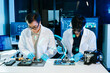 © Nuttapong punna - Asian engineers and scientists working with computer hardware, AI systems and digital technology
