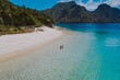 © oneinchpunch - Couple enjoying time  in front of the beach in Coron. Concept about summer, lifestyle,wanderlust travel and nature