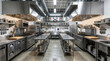 © IJ-studio - Clean and well-lit commercial kitchen with stainless steel countertops, professional equipment, and cooking stations
