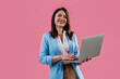 © oneinchpunch - Young businesswoman smiling and holding a digital tablet