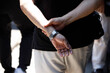 © dan quiet life - Male standing hands crossed behind back, hands and arm skin, unposed movement, close up.