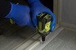 © TanyaArt - Hands using cordless drill to install door threshold indoors