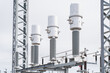 © K - Industrial electrical infrastructure featuring large ceramic insulators and metal housing for high tension voltage regulation and national power supply network maintenance