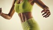 © Nasima - Fit womans midsection showcasing toned abdominal muscles in vibrant green activewear