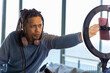 © wavebreak3 - African American man adjusting pink phone on ringlight near balcony with headphones, copy space