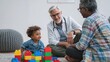 © Mary - Doctor meets with child and parent at home, smiling and discussing health while they play with colorful building blocks during a wellness checkup.