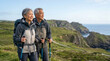 © TheLestari - Happy senior Asian couple trekking on coastal path