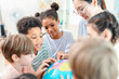 © chokniti - Back to school and education concept of children classroom teacher globe learning together in bright school activity