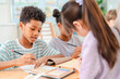 © chokniti - Back to school and education concept of child classroom art lesson creative drawing and painting with diverse student at table in bright school room