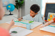© chokniti - Back to school and education concept of child painting in classroom, creative art lesson with focused student at table