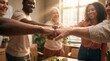 © Hypnyo - Diverse business team performing a fist bump in a sunlit office. Successful collaboration, teamwork and community support for corporate unity.