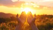 © Yasing - A pair of hands are outstretched towards a vibrant sunset, capturing a moment of serenity and connection with nature's beauty.